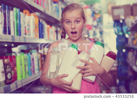 Portrait of happy girl holding a lot of shower gel Portrait of happy girl holding a lot of shower gel 43533258