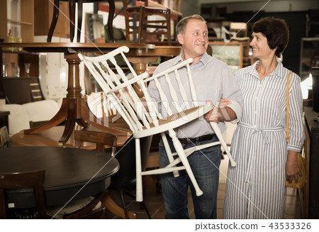 Happy couple is shopping the old armchair Happy couple is shopping the old armchair 43533326