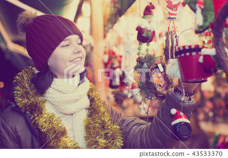 Teenager near counter with Christmas gifts Teenager near counter with Christmas gifts 43533370
