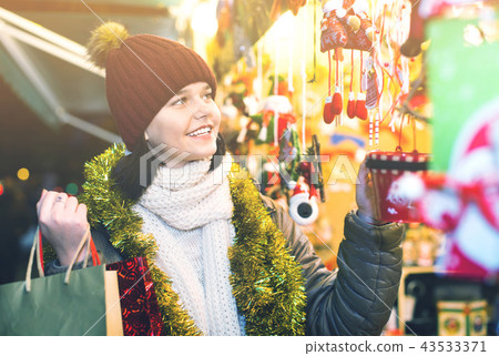 Teenage girl shopping at festive fair before Xmas Teenage girl shopping at festive fair before Xmas 43533371