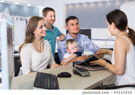 cheerful family of four choosing fabric for upholstery mattress in salon cheerful family of four choosing fabric for upholstery mattress in salon 43533450