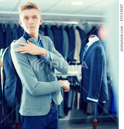 man costumer trying jacket in mirror indoors man costumer trying jacket in mirror indoors 43533697
