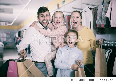 family of four with shopping bags 43533762