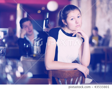 Woman unhappy because her boyfriend drinking in cafe Woman unhappy because her boyfriend drinking in cafe 43533801