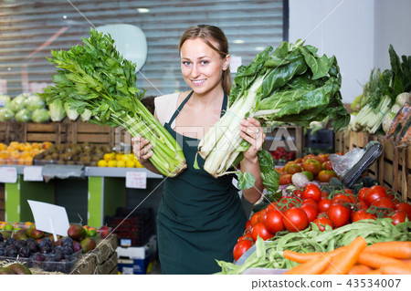 woman selling fresh greens on market . 43534007