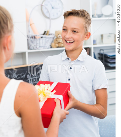 Girl is congratulation friend with his birthday Girl is congratulation friend with his birthday 43534010