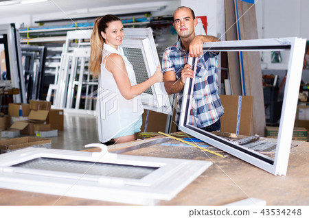 Manager of workshop for assembly of plastic windows with satisfied female client Manager of workshop for assembly of plastic windows with satisfied female client 43534248