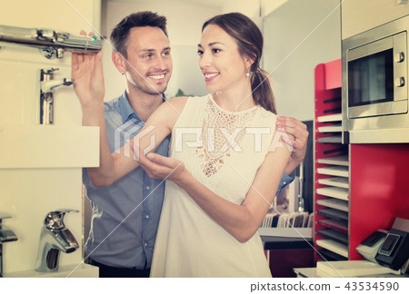 Family couple looking for modern functional mixer tap Family couple looking for modern functional mixer tap 43534590