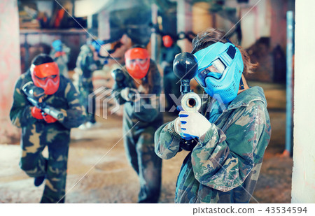 Player aiming in opponents in paintball field Player aiming in opponents in paintball field 43534594