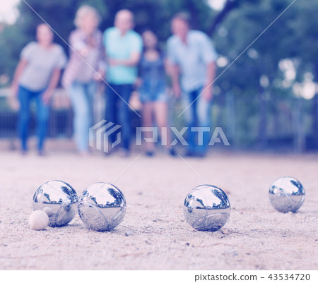 Males and females playing petanque Males and females playing petanque 43534720