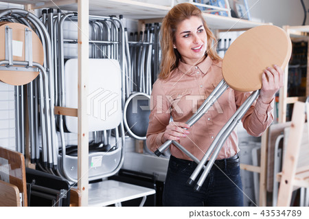 Glad woman looking for new stylish tabouret 43534789