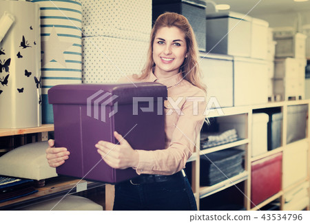 Girl choosing new comfortable ottoman 43534796