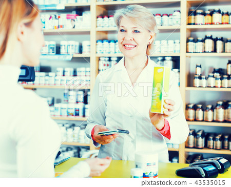 Seller helping customer to choose care products Seller helping customer to choose care products 43535015