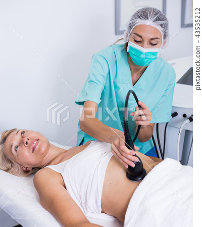 Woman receiving cryoliposuction Woman receiving cryoliposuction 43535212