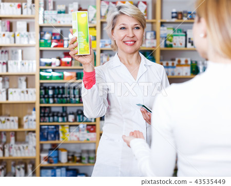 Seller helping customer to choose care products 43535449
