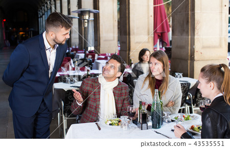 Angry customers in restaurant talking with administrator 43535551