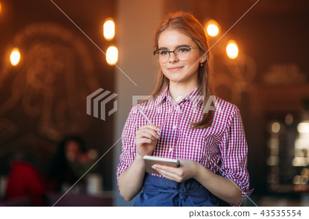 Portrait of a beautiful friendly waitress in glasses with notepapers and pen ready to take your Portrait of a beautiful friendly waitress in glasses with notepapers and pen ready to take your 43535554