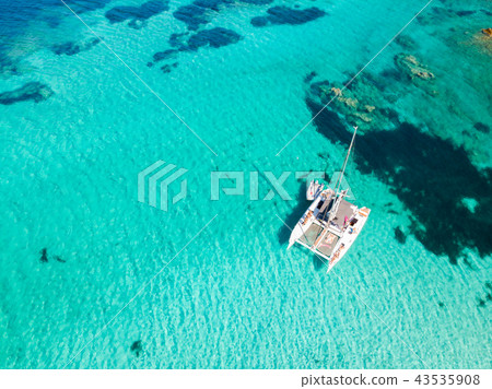 Drone aerial view of catamaran sailing boat in Maddalena Archipelago, Sardinia, Italy. 43535908