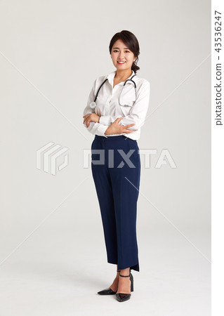 A doctor in her twenties holding a stethoscope, a doctor, a stethoscope 43536247