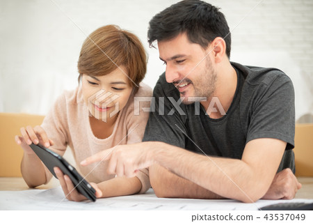 Couple with digital tablet Couple with digital tablet 43537049