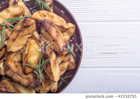 Homemade grilled potatoes with rosemary Homemade grilled potatoes with rosemary 43538785