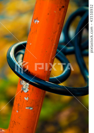 A black bike lock on an orange bike 43538932