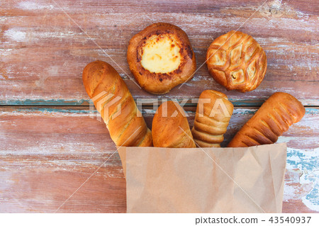 Bakery products in paper bag on table. Top view. 43540937