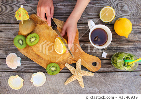 Woman prepares tea with lemon. Top view. 43540939