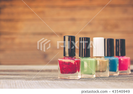 Nail polish on the old wooden background. 43540949