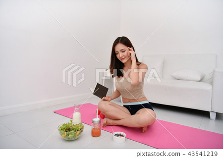 The concept of weight loss. Asian girls are looking for knowledg 43541219