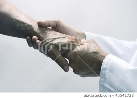 man moving the hand of a senior patient. man moving the hand of a senior patient. 43541728