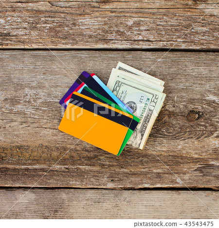 Credit card and dollars on wooden background. 43543475