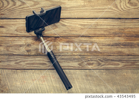 Mobile phone on selfie stick Mobile phone on selfie stick 43543495