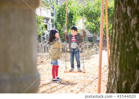 Children playing with swing 43544020