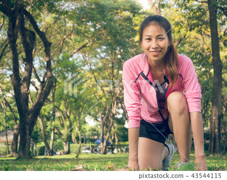 Asian woman on mark to set ready for jogging. 43544115