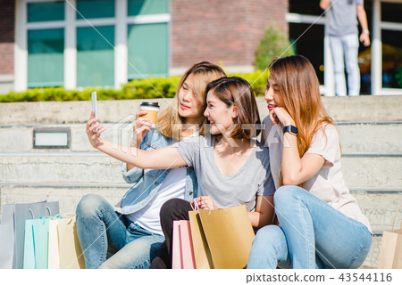 woman using smartphone while shopping in the city. woman using smartphone while shopping in the city. 43544116