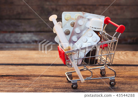 Shopping cart with pills, syringe Shopping cart with pills, syringe 43544288