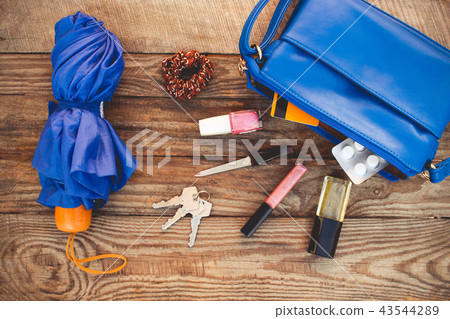 Blue purse, umbrella and women's accessories. Blue purse, umbrella and women's accessories. 43544289
