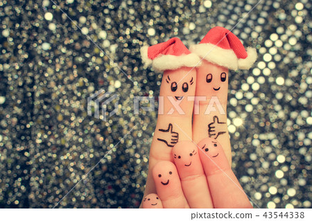 Finger art of large family celebrates Christmas.  43544338