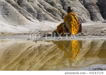 eastern woman on the lake shore 43547174