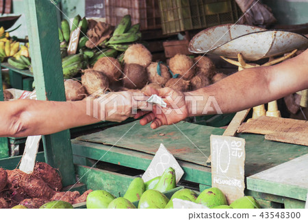 Money changing hands at a market in Havana cuba Money changing hands at a market in Havana cuba 43548300