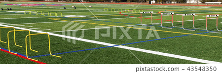 Turf field set up with hurdles and medicine balls Turf field set up with hurdles and medicine balls 43548350