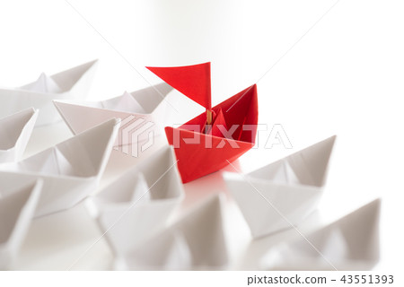 Red paper ship lead among white 43551393