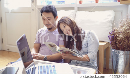 Couple of Asian Lover sitting together and reading book in the morning with warm feeling at modern co-working space, Lifestyle and leisure with love concept Couple of Asian Lover sitting together and reading book in the morning with warm feeling at modern co-working space, Lifestyle and leisure with love concept 43552064