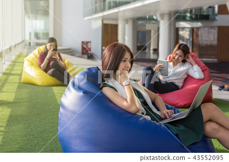 three women using social network each technology equipment In the modern creative Office, business social network concept three women using social network each technology equipment In the modern creative Office, business social network concept 43552095