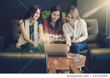 Group Of Asian Businesswomen with casual suit brainstorm Meeting with looking at tablet In the coffee shop, business technology concept Group Of Asian Businesswomen with casual suit brainstorm Meeting with looking at tablet In the coffee shop, business technology concept 43552099