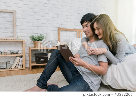 Happy Asian couple reading the book or notebook on the bed in the bedroom at modern home, Lover and life style concept 43552205
