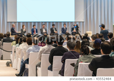 Rear view of Audience in the conference hall or seminar meeting which have Speakers on the stage, business and education about investment concept Rear view of Audience in the conference hall or seminar meeting which have Speakers on the stage, business and education about investment concept 43552464