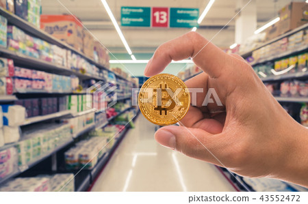 Closeup hand holding bitcoin over the Abstract blurred photo of store in department store bokeh background, Block chain technology of Crypto concept, Business and future concept Closeup hand holding bitcoin over the Abstract blurred photo of store in department store bokeh background, Block chain technology of Crypto concept, Business and future concept 43552472