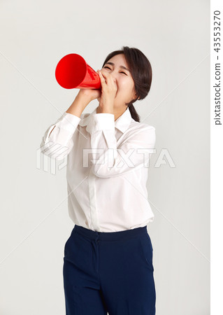 A twenties business woman communicating with the world. A loudspeaker, yell, 43553270